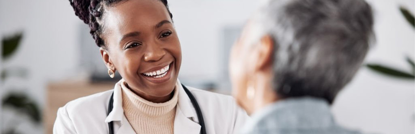 Pain management female doctor with older female patient.