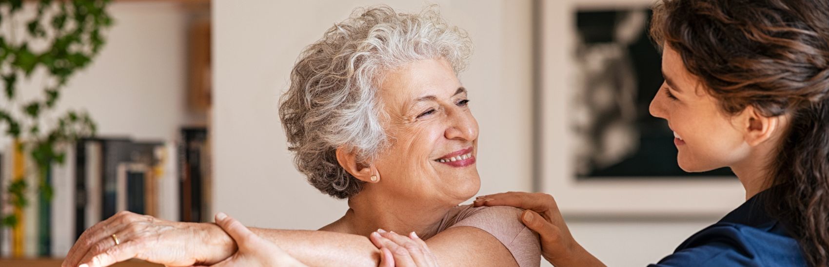 An elderly lady smiling at her pain management nurse.