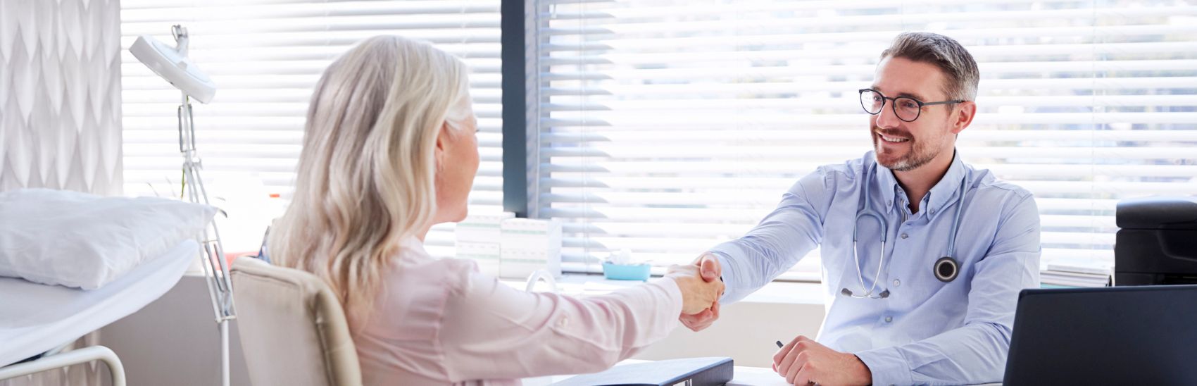 A doctor shaking hands with his patient with chronic pain.