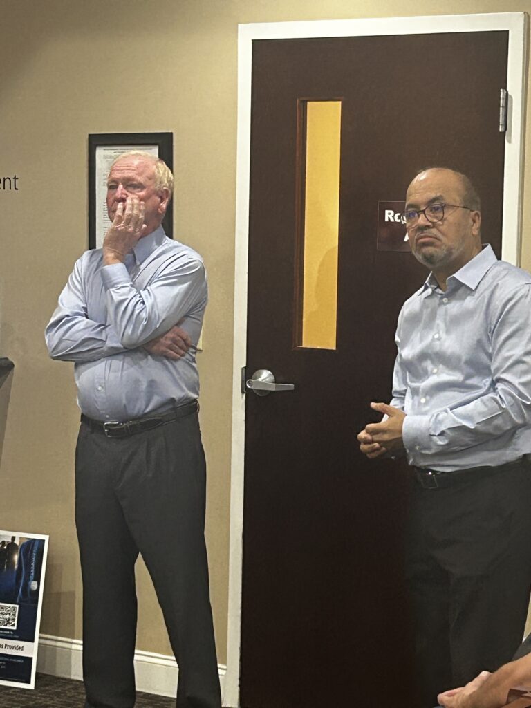 Dr. Daniel and Dr. Yagnick listen to attendee questions about spinal stimulation.